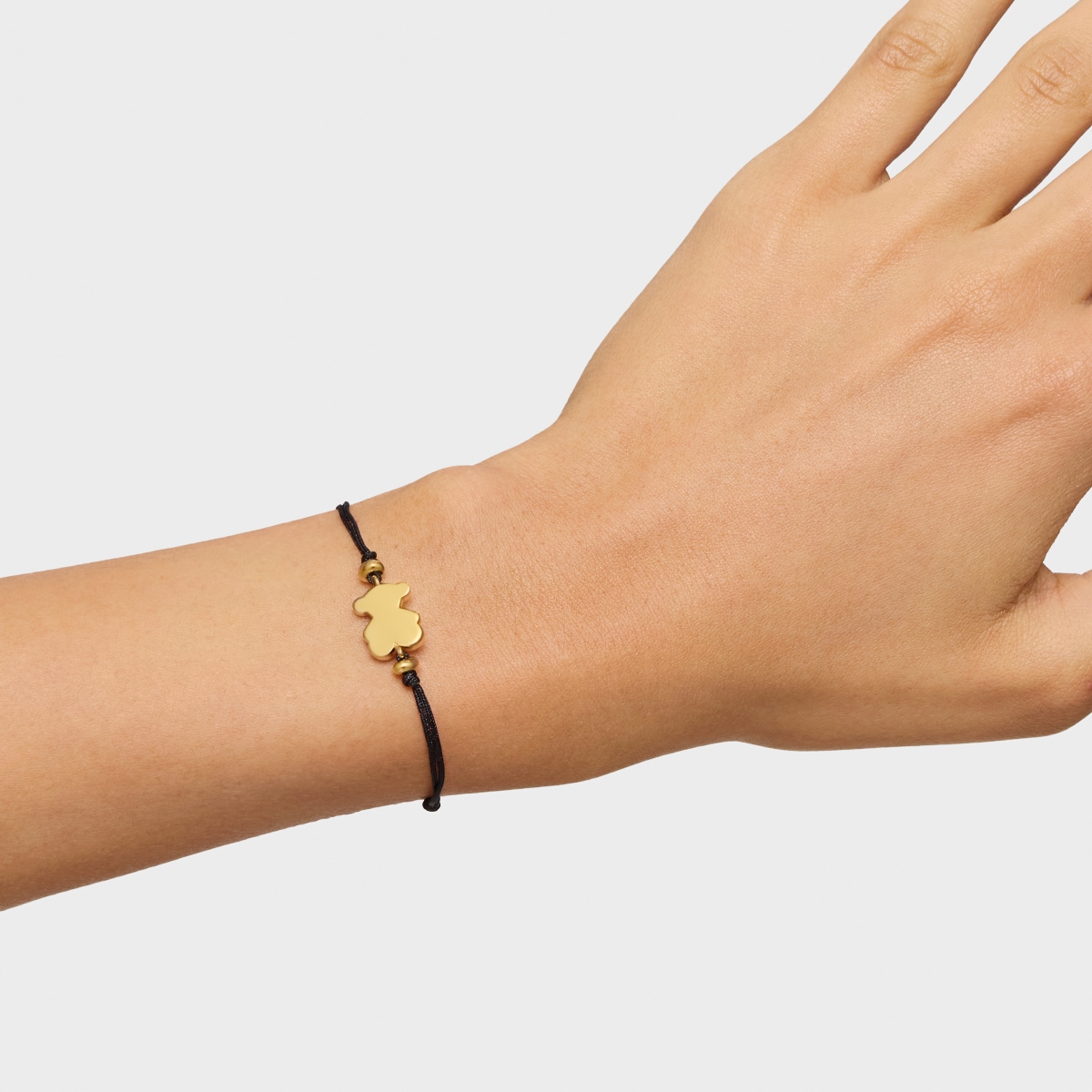 Pulsera con baño de oro 18 kt sobre plata y nylon negro con motivo oso Sweet Dolls
