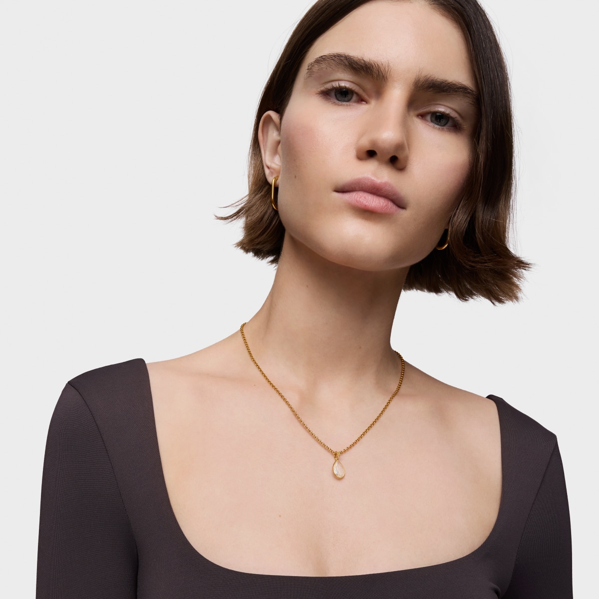 Colgante pequeño con baño de oro 18 kt sobre plata y cristal de roca Medallions