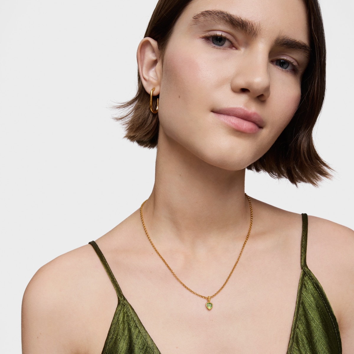 Colgante pequeño con baño de oro 18 kt sobre plata y peridoto Medallions