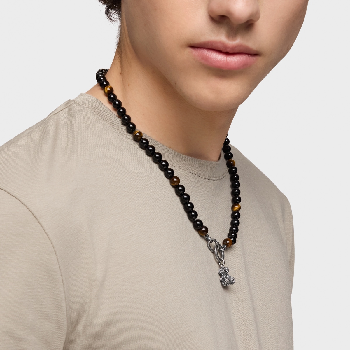 Silver necklace with onyx, tiger’s eye, and Hold Man rings
