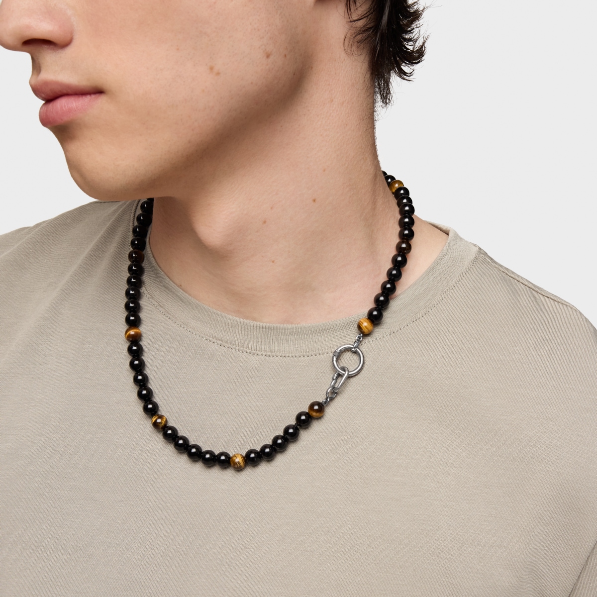 Silver necklace with onyx, tiger’s eye, and Hold Man rings