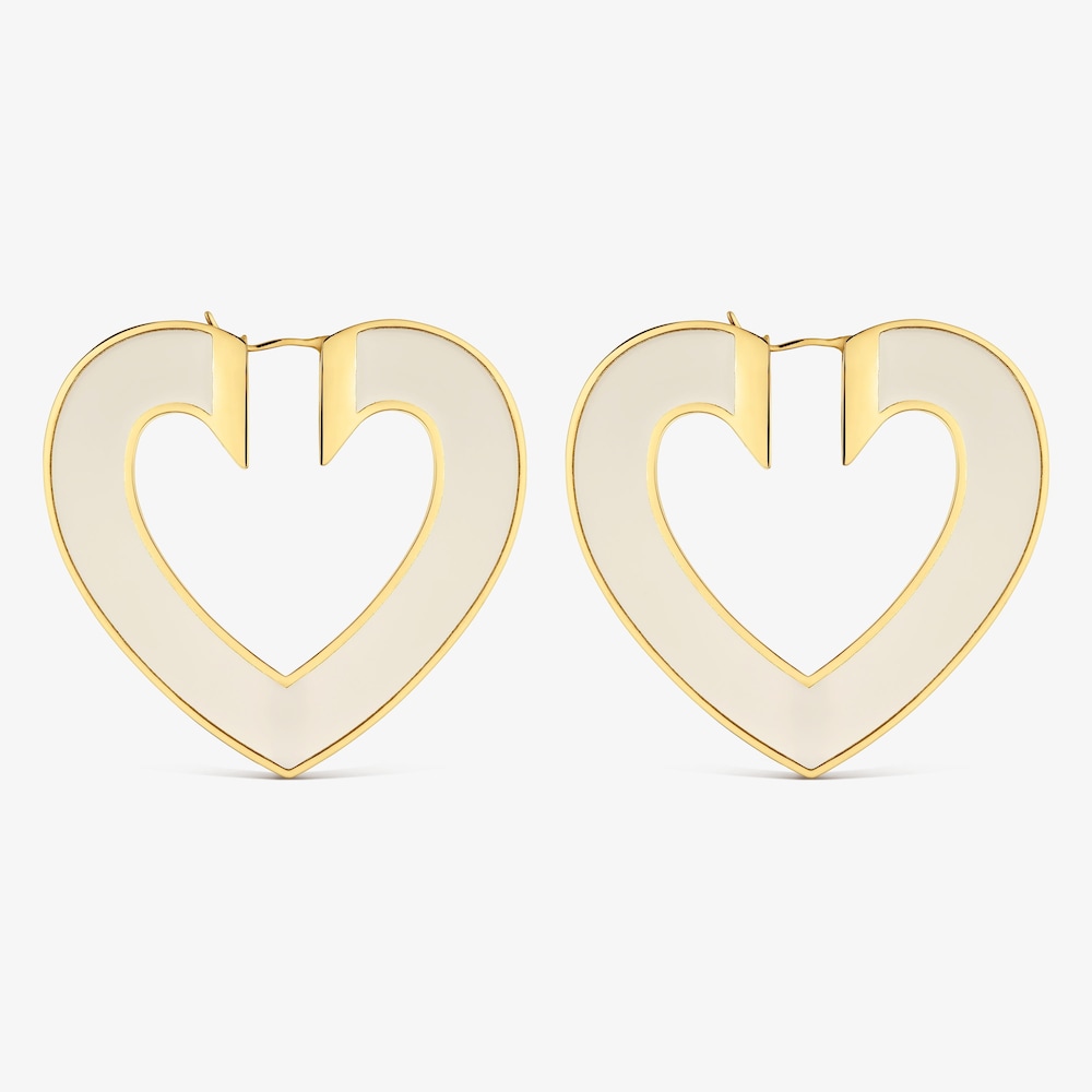 N&aacute;u&scaron;nice ve tvaru srdce o&nbsp;velikosti 50&nbsp;mm z&nbsp;oceli ve zlat&eacute; barvě a&nbsp;b&iacute;l&eacute; pryskyřice TOUS Galaxy