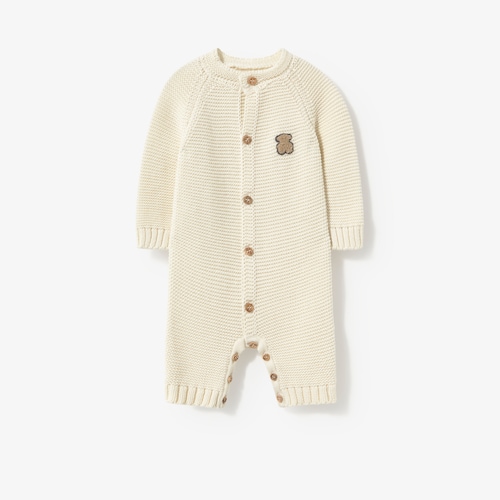Newborn baby romper in natural-coloured knit