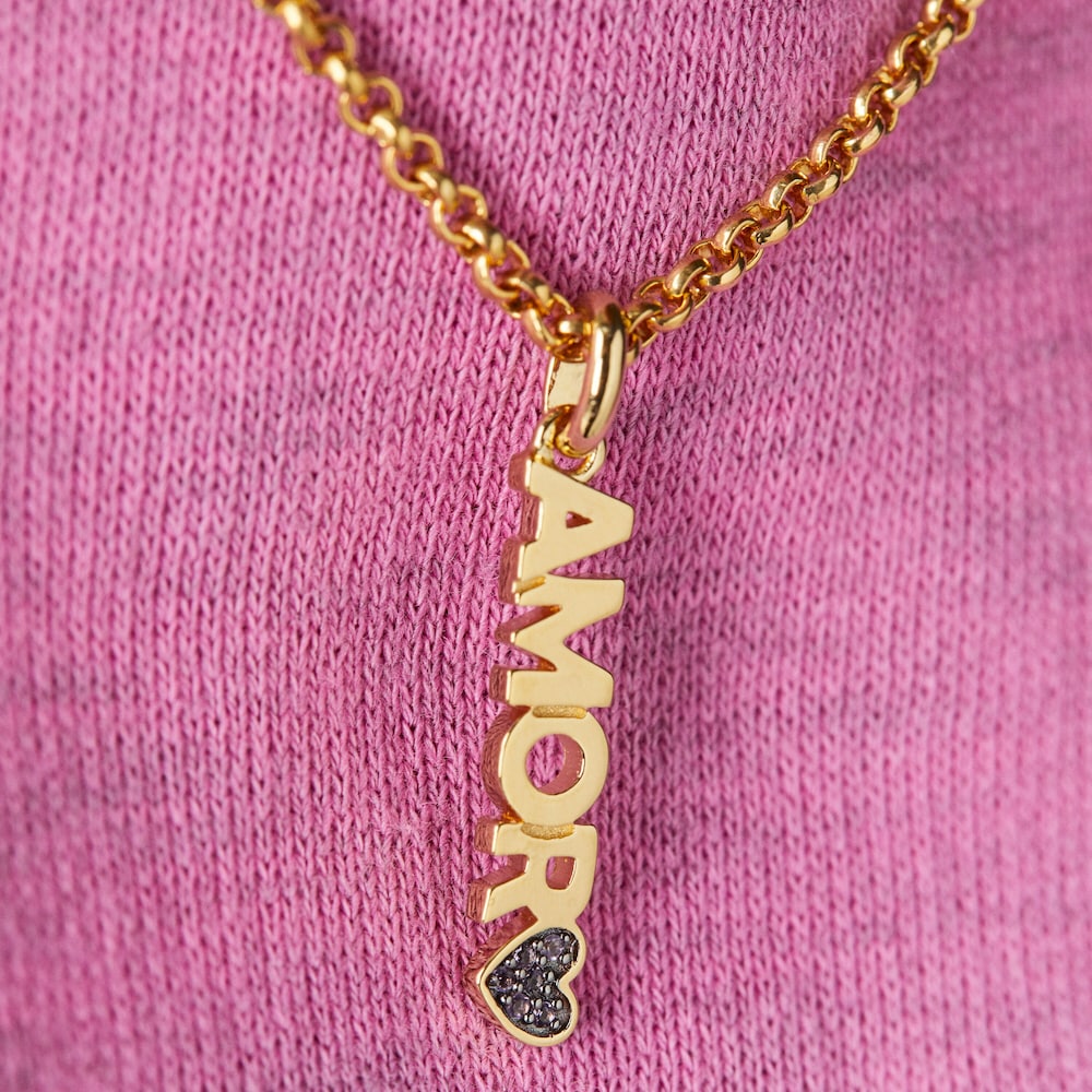 Dije Amor con amatista TOUS Crossword