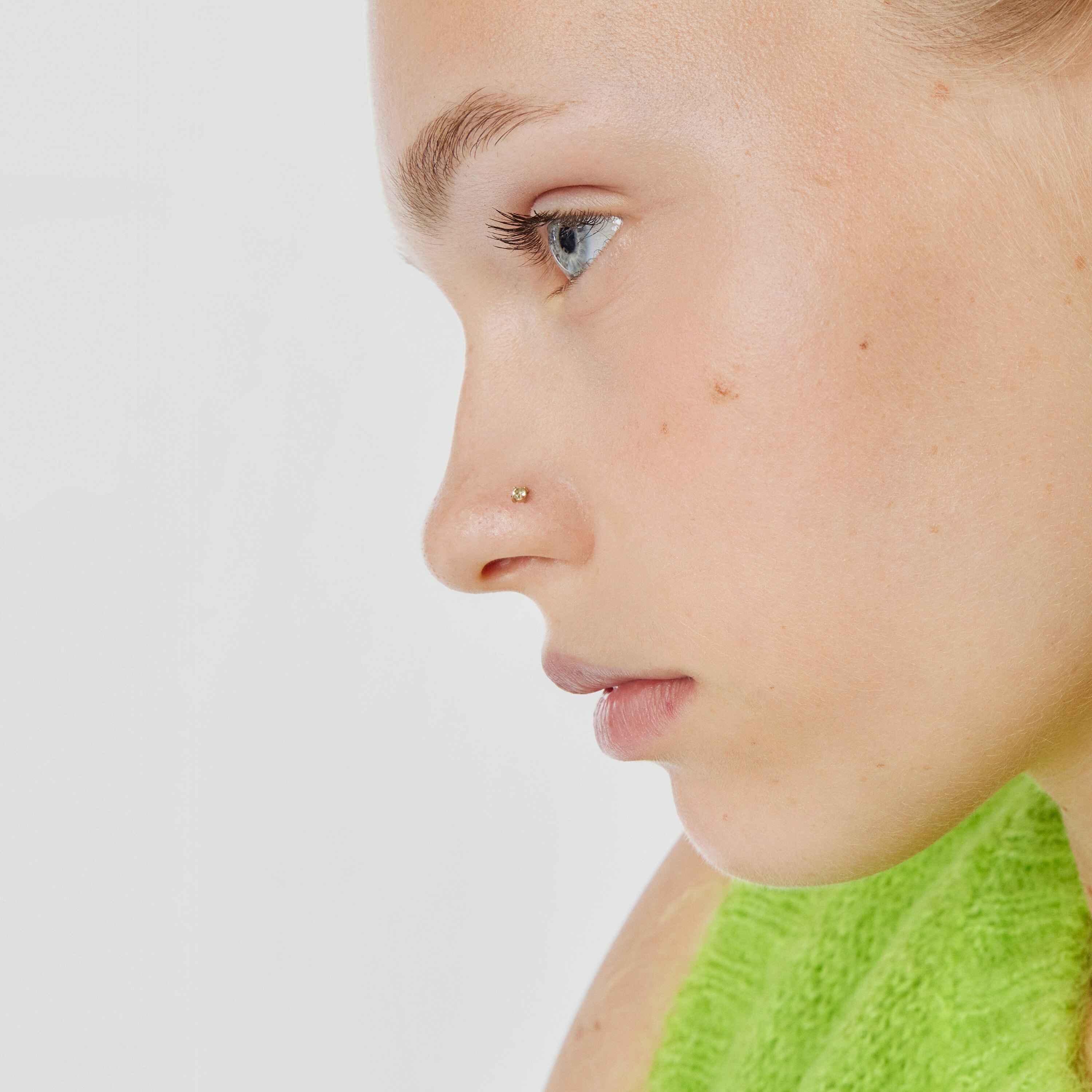 Gold-colored IP steel and garnet and peridot Beach Nose piercing