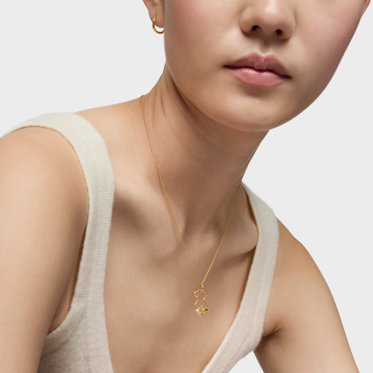 Gold Tsuri Bear pendant with gemstones and a cultured pearl