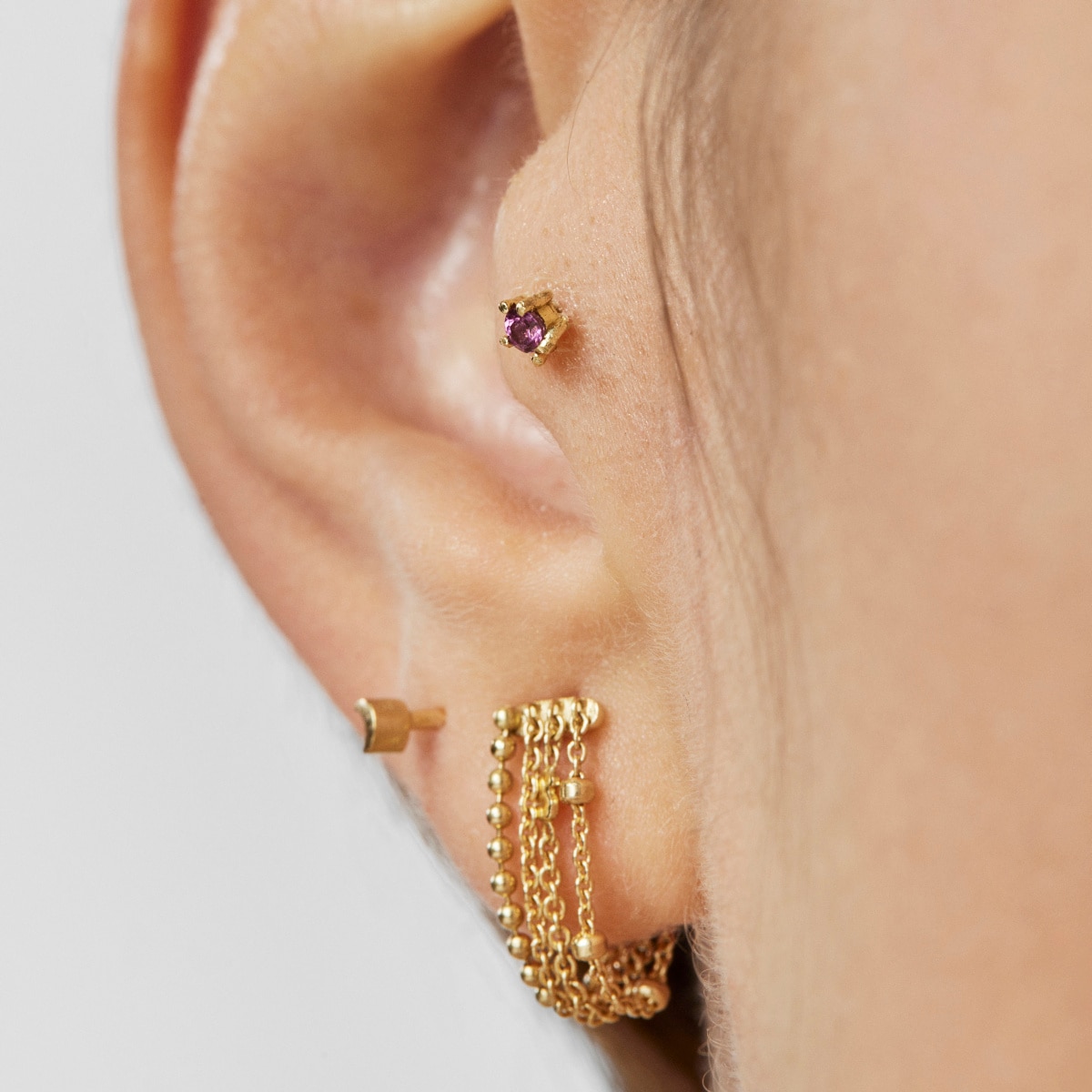 Gold TOUS Cool Joy Ear piercing with rhodolite