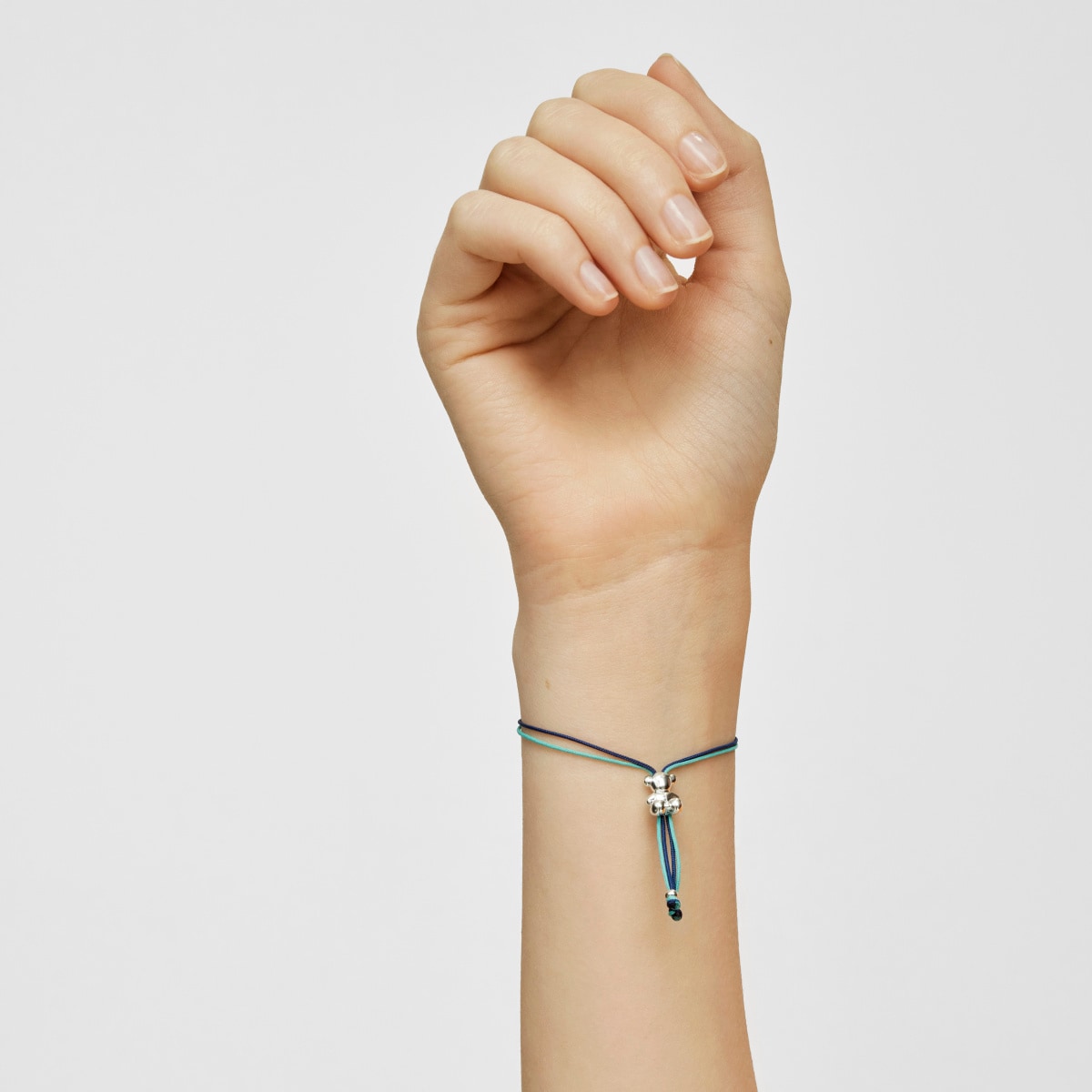 Bold Bear Bracelet with turquoise and navy blue cord and a silver bear