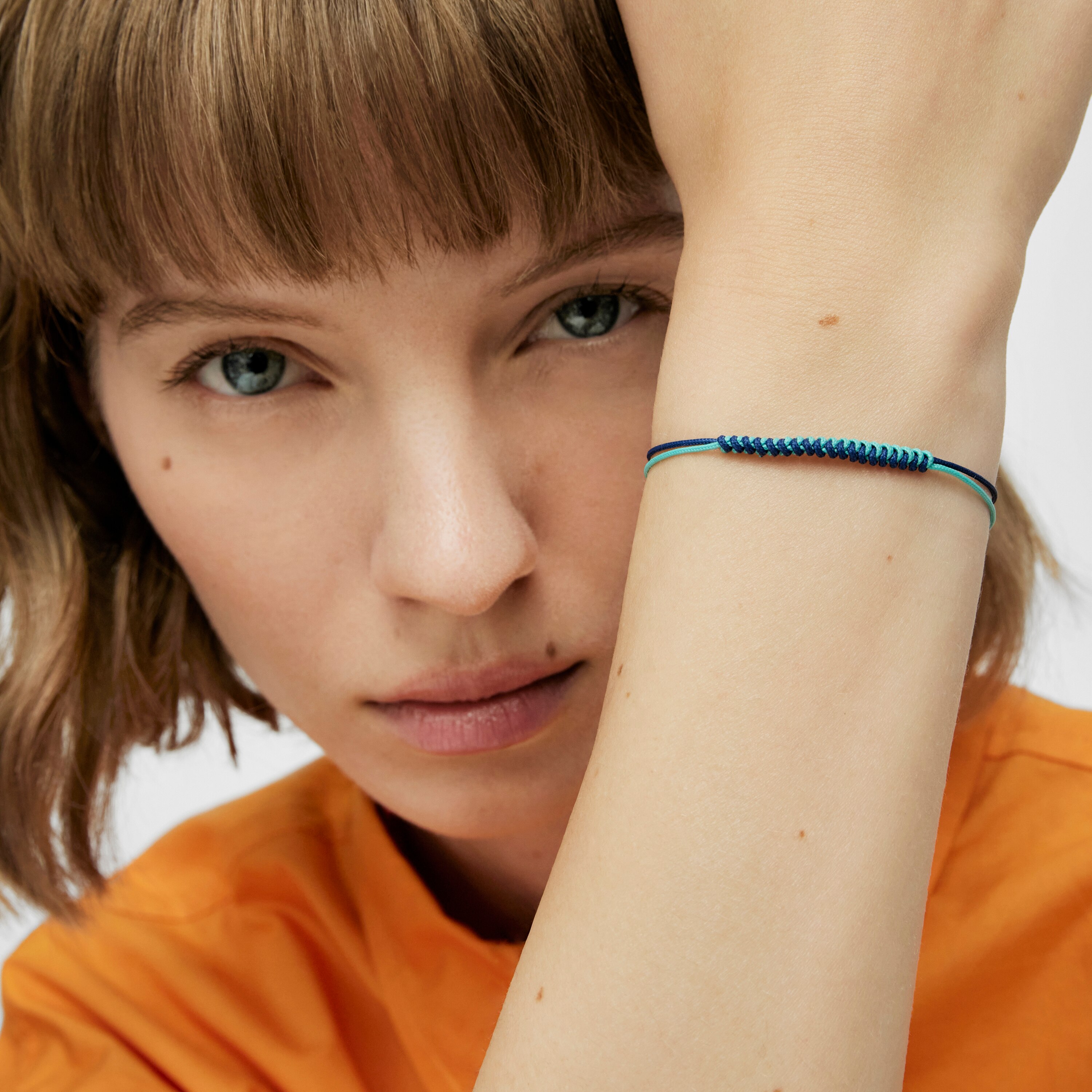 Bold Bear Bracelet with turquoise and navy blue cord and a silver bear