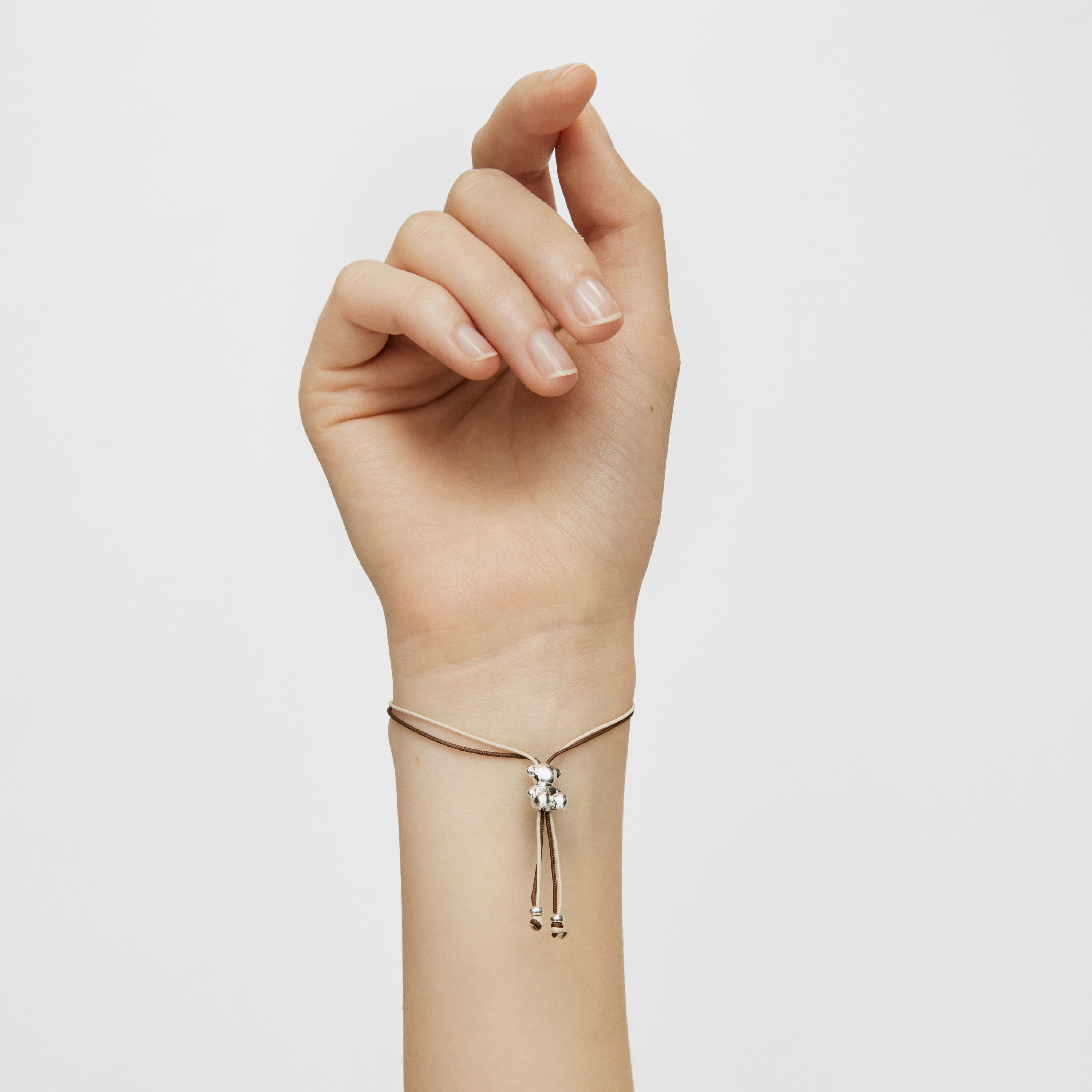 Bold Bear Bracelet with brown and beige cord and a silver bear