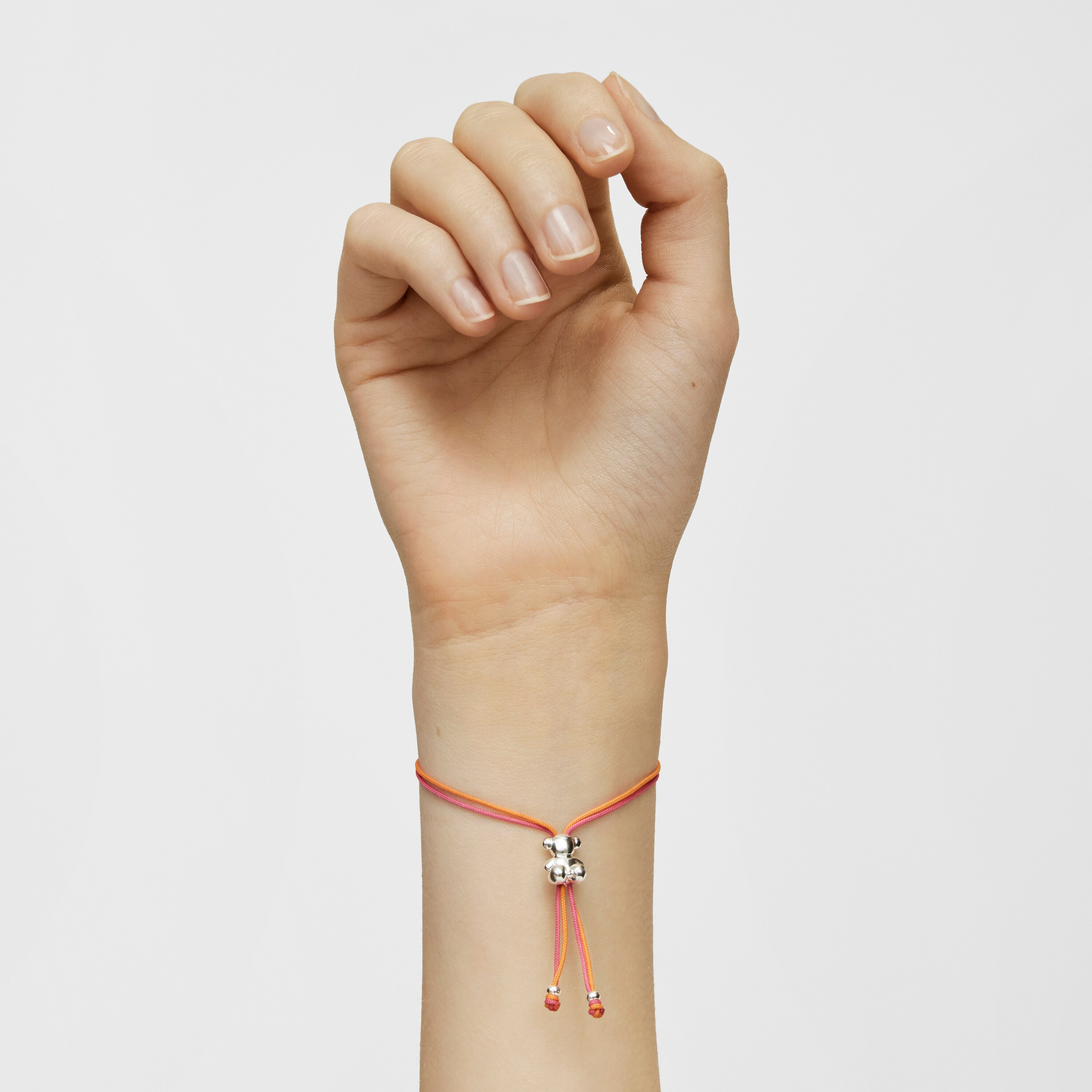 Bold Bear Bracelet with fuchsia and orange cord and a silver bear