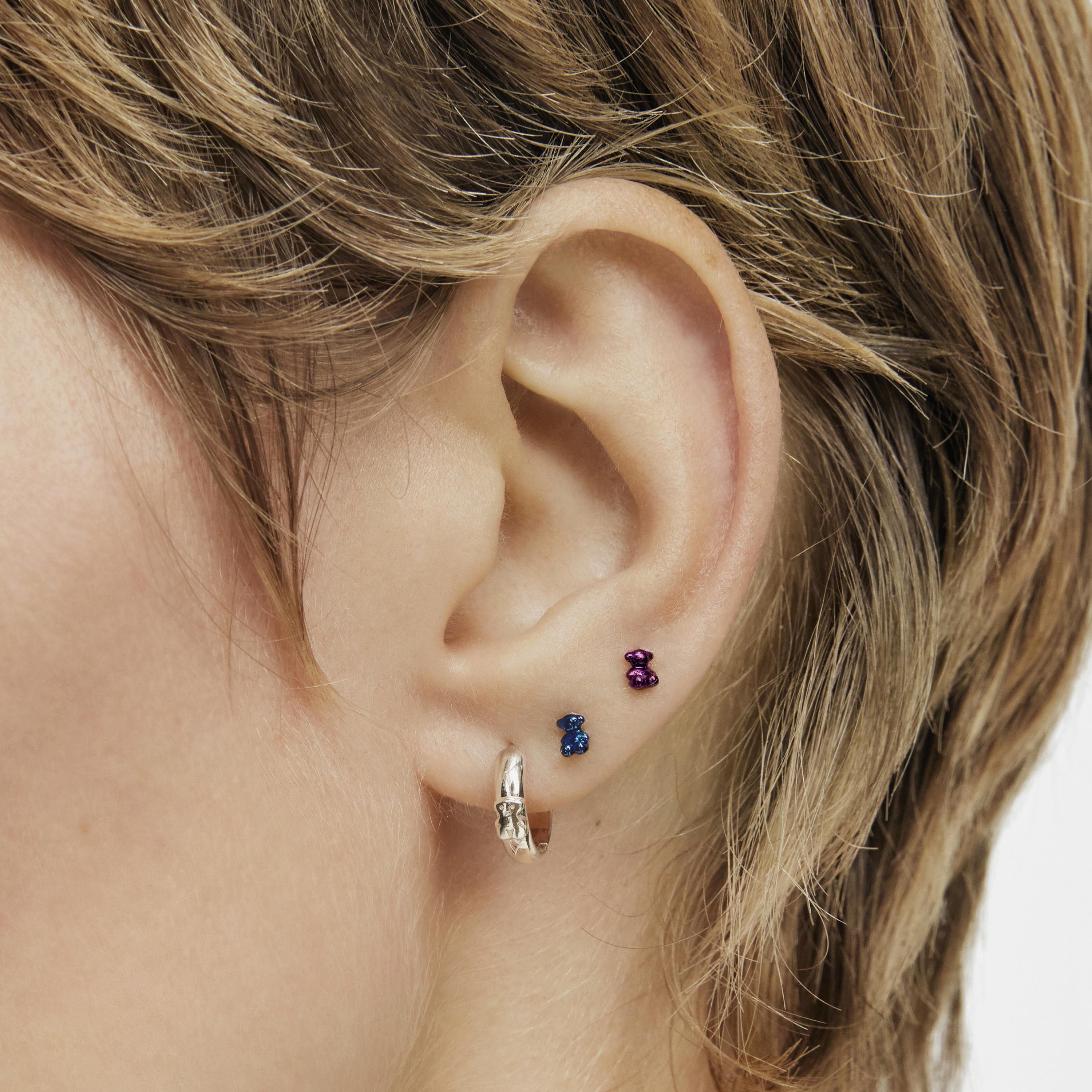 Pack of Bold Bear Ear piercings in lilac- and green-colored IP