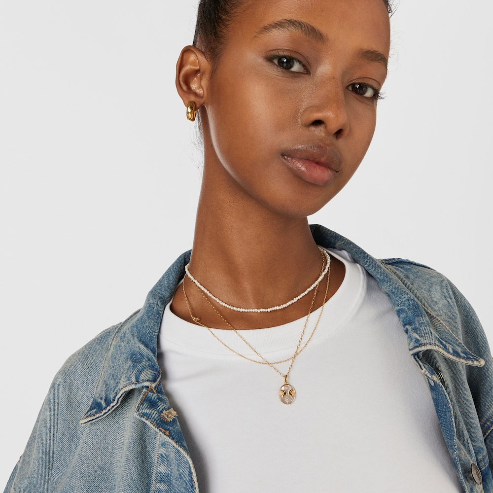 Colgante G&eacute;minis con ba&ntilde;o de oro 18 kt sobre plata, n&aacute;car y topacios TOUS Horoscope