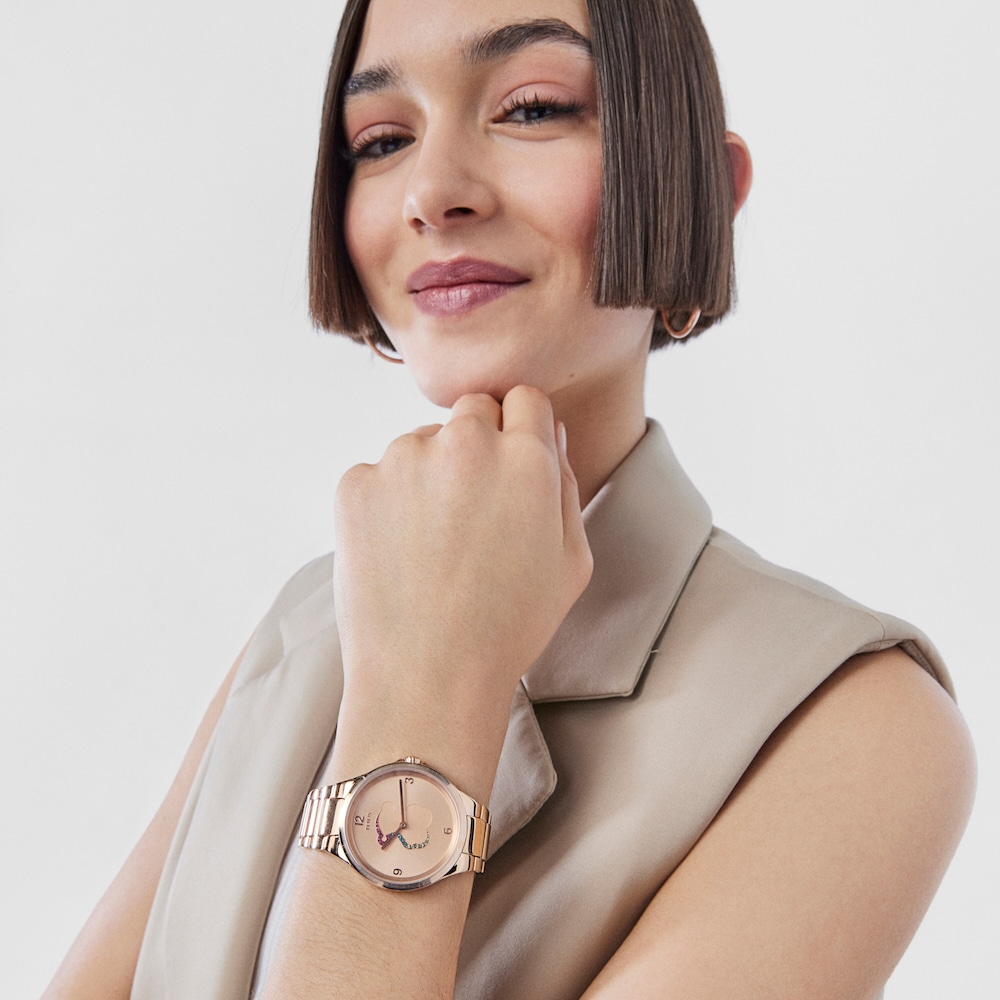 Reloj anal&oacute;gico Motion de acero IP rosado con cristales de colores